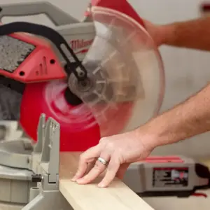 House of Heroes Volunteer Using Saw