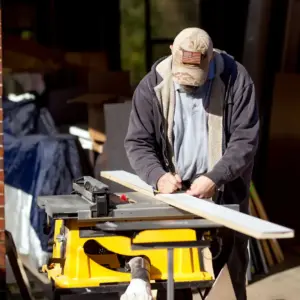 House of Heroes Volunteer Measuring Lumber