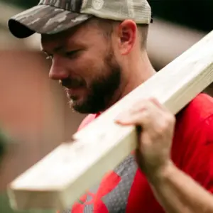 House of Heroes Volunteer Moving Lumber